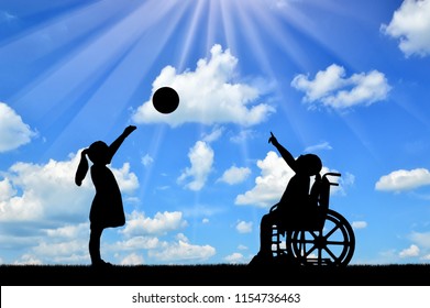 Silhouette Of A Disabled Child Girl In A Wheelchair And Healthy Girl Playing In A Ball Outdoors. The Concept Of Children With Disabilities In A Society Of Healthy Children