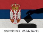 Silhouette hand election vote on Serbia flag wall background