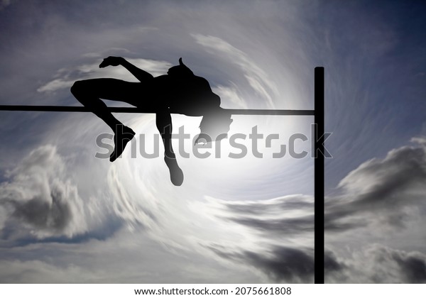 Silhouette of a high jumper athlete hurtle over an\
obstacle bar against a surreal cloudy sky for the concept of\
successful accomplishment.\
