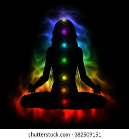 Silhouette of long hair woman meditating - colored chakras