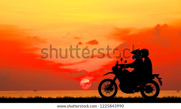 日没にクラシックバイクで恋人同士のシルエット のイラスト素材
