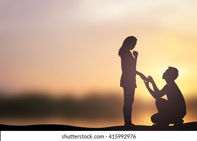 silhouette of man ask woman to marry on sea beach mountain background concept - Powered by Shutterstock