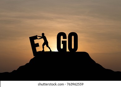 Silhouette man change EGO to GO text on Mountain, sky and sun light background. Business, success, challenge, motivation, achievement and goal concept.