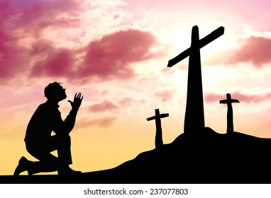 Silhouette of man praying to a cross with heavenly cloudscape sunset concept for religion
