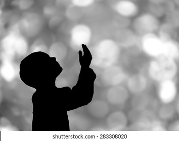 Silhouette Of A Muslim Praying Bokeh  Background 