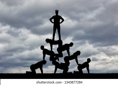 Silhouette Of A Narcissist Male Businessman Selfish With A Crown On His Head Is Standing On People. The Concept Of Selfish And Narcissist Boss