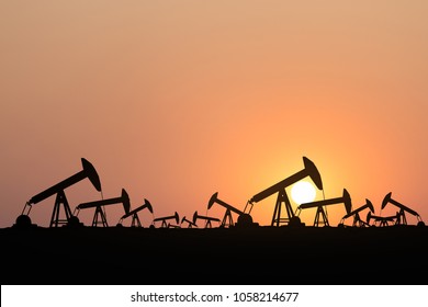Silhouette of oil pump oil rig energy industrial machine for petroleum at sunset background. 