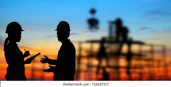  silhouette portrait of engineer Work order in construction site on blurry colorful light sunset. - Powered by Shutterstock