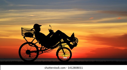 Silhouette Recumbent Bicycle On Sunrise