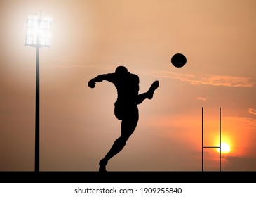 Silhouette of a rugby player scoring a dropkick goal under a stadium floodlight. 