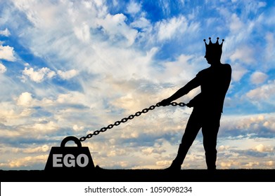 The silhouette of a selfish man with a crown on his head draws a heavy load under the name of the ego. The concept of selfishness and narcissism as a problem for a normal life