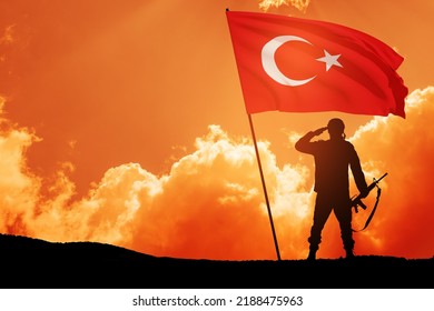 Silhouette Of Soldier With Turkey Flag Against The Sunrise Or Sunset. Concept Of Crisis Of War And Conflicts Between Nations. Greeting Card For Turkish Armed Forces Day, Victory Day.