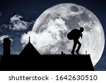 Silhouette of a thief with stolen loot tiptoe across the roof of a house at midnight for the concept of stealing at twilight. Elements of this image furnished by NASA.