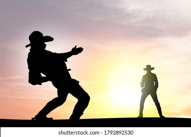 Silhouette Of Two Cowboy Gunslinger Engaged In A Shootout At Sunset.