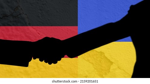 Silhouette Of Two Men Shaking Hands Against Ukraine And Germany Flag Background. International Relations Concept