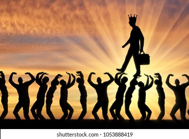 Silhouette of a walking selfish and narcissistic man with a crown on his head on the hands of the crowd. The concept of selfishness and narcissistic personality