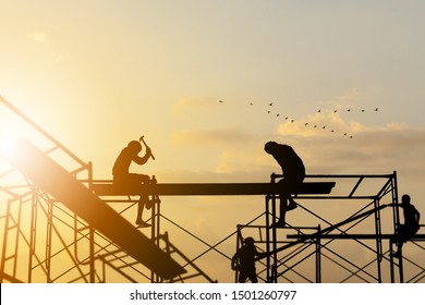 Silhouette of worker on building site, construction site at sunset in evening time. - Powered by Shutterstock