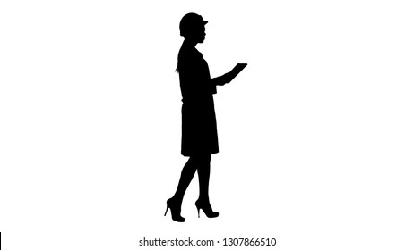 Silhouette Young woman engineer walking with tablet looking at objects around. - Powered by Shutterstock