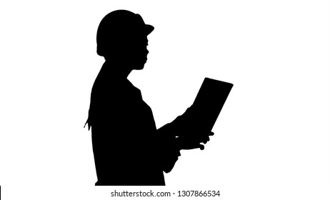 Silhouette Young woman engineer walking with tablet looking at objects around. - Powered by Shutterstock