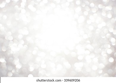 Silver white glittering Christmas lights. Blurred abstract background