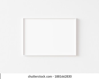 Single blank horizontally oriented rectangular picture frame with thin white border hanging on white wall. 3D illustration.
