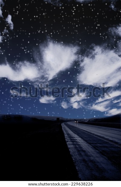 Single car travels\
on dark road under\
stars