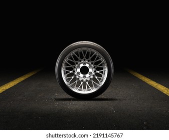 Single Car Wheel On A Garage Floor From Front View. Rubber Tire With Shiny Chrome Rim. 3d Rendering, Nobody