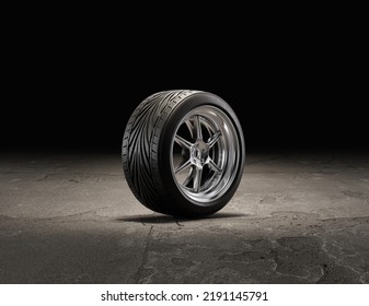 Single Car Wheel On A Garage Floor. Rubber Tire With Shiny Chrome From Side View. 3d Rendering, Nobody