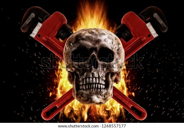 Skull and wrench in fire on a\
black background. Photo manipulation artwork, 3D\
rendering.