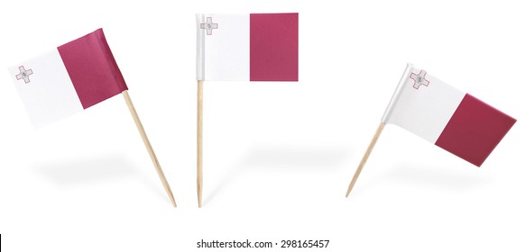 Small cocktail flags of Malta in different positions isolated on white.(series) . Also easy to use as a design element :) 