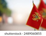 Small flags of Montenegro on a blurred background