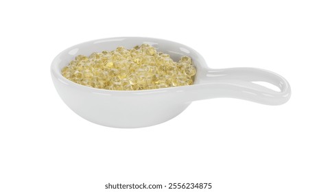 A small white dish filled with translucent yellow beads, possibly used for culinary decoration or as a food ingredient. - Powered by Shutterstock