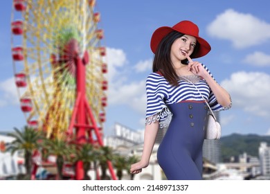 A smiling woman in a red hat under a blue sky wearing a striped top and high-waisted wide pants posing with a large Ferris wheel in the background, holding her index finger to her mouth.3D illustratio