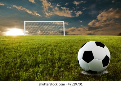 Soccer ball on penalty disk in sunset time