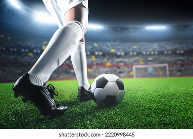 Soccer player in action on sport stadium background, kicking ball - Powered by Shutterstock