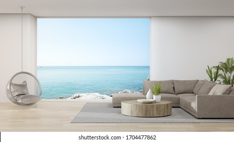 Sofa On Wooden Floor Of Large Living Room In Modern House Or Luxury Hotel. Minimal Home Interior 3d Rendering With Sky And Sea View.