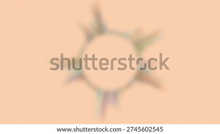 A soft focus graphic features a circular shape in the center with abstract colorful rays emanating outwards, resembling a sunburst or a sound wave visualization.