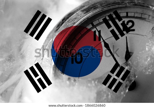 South Korea, Korean flag with\
clock close to midnight in the background. Happy New Year\
concept