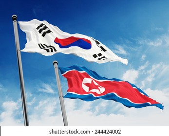 South And North Korea Flags Against Blue Sky Background.