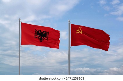 Soviet Union or USSR and Albania flags waving together in the wind on blue cloudy sky, two country relationship concept