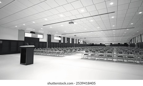 A spacious conference hall with rows of chairs and a podium, set up for a large meeting or seminar. 3d render - Powered by Shutterstock