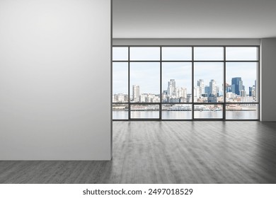 Spacious, empty modern interior with large windows showcasing a cityscape. Grey flooring and blank wall. Ideal for mockup and template use. 3D Rendering