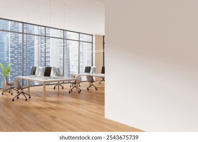 Spacious modern office interior with computers on desks and a large blank wall. Wooden floor, cityscape background. Concept of workspace design. 3D Rendering - Powered by Shutterstock