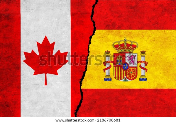 Spain and\
Canada painted flags on a wall with a crack. Spain and Canada\
relations. Canada and Spain flags\
together