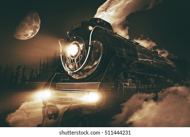 Speeding Steam Locomotive Crossing Rocky Mountains At Night. 