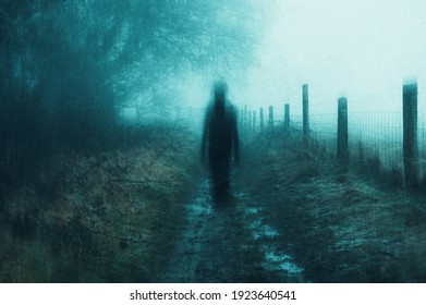 A Spooky Concept Of A Ghostly Figure Walking On A Path Through A Spooky Country Path On A Moody, Foggy Winters Day. With A Grunge, Abstract Edit. England, UK, Bredon Hill