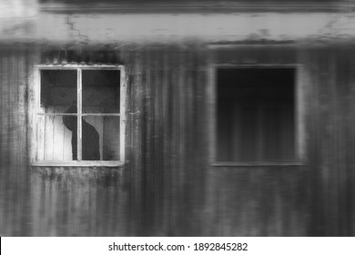 A Spooky Horror Concept Of A Dark Hooded Figure Standing At A Window. With An Abstract Blurred Edit. 