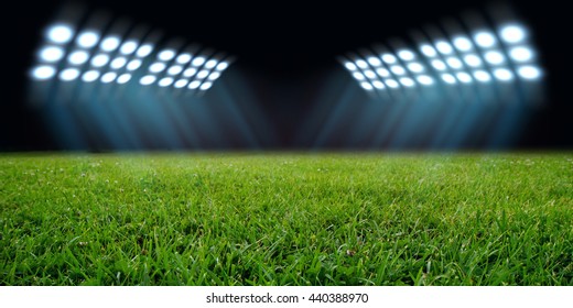 sport stadium in spotlight with green grass field - Powered by Shutterstock