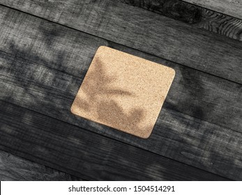 Square Cork Pad Or Beer Coaster Mockup On The Wooden Table Outdoor. 3d Rendering