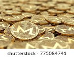 Stack of golden Monero coins in blurry closeup with copy space above in blurred area. 3D rendering